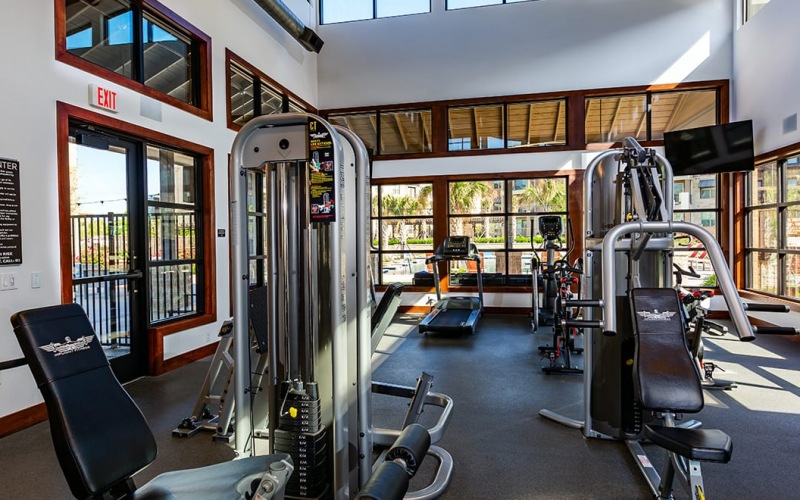 workout equipment in the wooden-themed wellness center