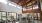 high-ceiling wellness center with wooden beams throughout and with ample natural lighting for moving and equipment-use