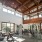 high-ceiling wellness center with wooden beams throughout and with ample natural lighting for moving and equipment-use